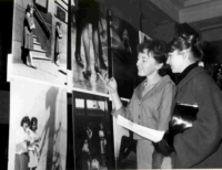 Image: Two women inspect photographs on display as part of the Urban Women exhibition at Melbourne Town Hall, 1963 (NLA)