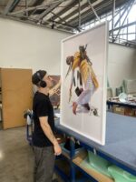 Fini Frames staff framing Martine Gutierrez for an exhibition at CCP for PHOTO 2022.