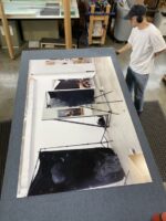 Fini Frames staff working on framing Paul Mpagi Sepuya's work for an exhibition at CCP for PHOTO 2022