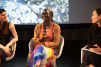 Atong Atem speaking at V&A Museum, with Zoe Croggon and V&A curator Catherine Troiano. Photo: Mathushaa Sagthidas.